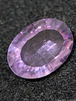Close-up of oval amethyst showing facets and color