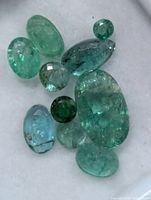 Loose emerald gemstones in display box