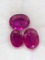 Three oval rubies on white background