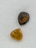 Top view of two loose diamonds on white pad