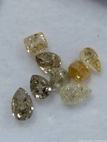 Close-up of eight loose fancy color diamonds