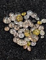 Loose mixed-color diamonds on black background