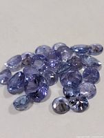 Group of loose faceted tanzanite stones spread out