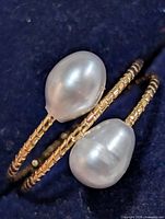 Close-up of two pearls and textured band