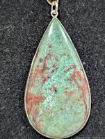 Front view of teardrop Sonora Sunset jasper pendant in silver setting