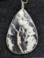 Front view of teardrop zebra jasper pendant in silver bezel