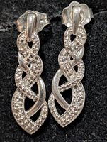 front view of both earrings showing intertwined design and diamonds