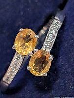 Top view of ring showing two oval citrines and clear accent stones