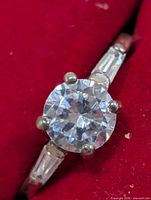 Front view showing round center stone and baguette sides