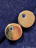 front view of both disc earrings showing blue stones