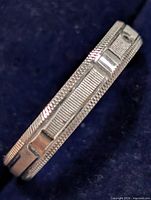 Side profile of band showing milgrain edge and geometric pattern