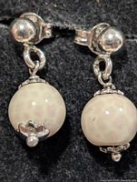 Front view of both silver pearl drop earrings showing pearls and silver caps