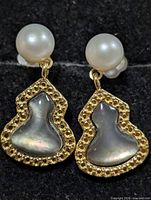 front view showing pearl studs and mother-of-pearl drops