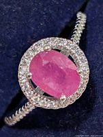 Close-up of ruby centre stone with CZ halo