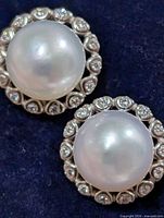 front view of both earrings showing pearls and stone halo
