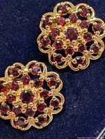 Front view showing floral garnet clusters