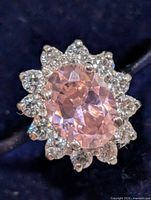 Top view showing oval pink centre stone and clear CZ halo