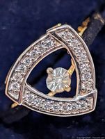 Front view showing triangular pavé diamond frame and central floating diamond