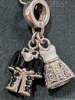 Front view showing tuxedo and dress charms, stones visible