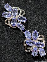 Close-up of upper earring showing tanzanite cluster setting