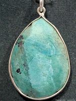 front view of turquoise pendant showing stone color and bezel