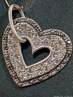 Front view of heart-shaped silver pendant with CZ and marcasite