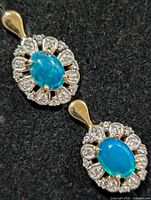 Front view of both earrings showing opal centers and CZ halo