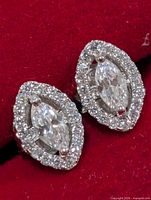 Front view of both earrings showing marquise CZ centers and halo setting