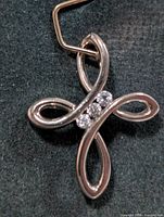 Front view of silver ribbon pendant with three CZ stones