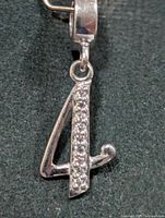 Front view of silver CZ number 4 pendant