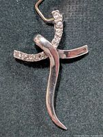 Front view of stylized silver CZ pendant