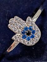 Close-up of Hamsa motif showing stone setting