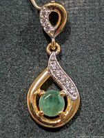 Front view showing emerald and clear stones