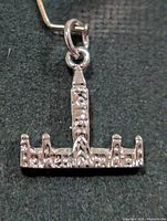 Front view of silver pendant showing full architectural shape and jump ring