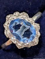 Top view showing blue oval stone and textured silver cluster