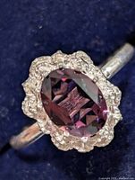 Ring top view showing purple stone and silver mount