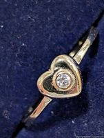 Front close-up of ring showing heart motif and stone