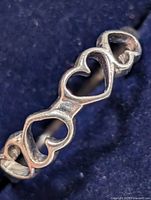 Front view of sterling silver ring showing open heart design