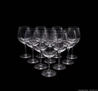 Group of ten identical clear balloon-bowl wine glasses