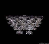 Group of 14 clear swirl Depression glass coupes displayed together