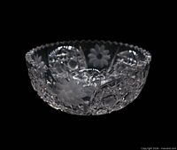 Side profile of clear crystal bowl showing daisy intaglio and geometric cuts