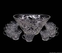Punch bowl with 19 matching cups displayed, starburst pattern visible