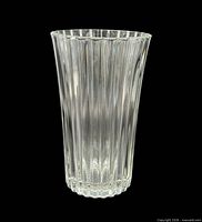 Full view of clear crystal vase showing vertical ribs and flared shape