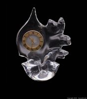 Full view of crystal mantle clock showing sculptural shape and dial