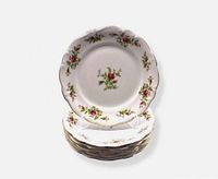 Stack of six Moss Rose dinner plates on stand