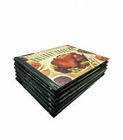 Stack of six spiral-bound cookbooks showing cover of Holiday Cooking