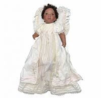 Full view of doll in gown and pillow bonnet