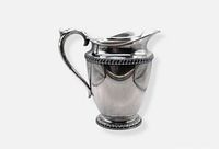 Full view of WM Rogers silverplate pedestal water pitcher showing shape, handle, pedestal base and gadroon rim