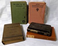 Group shot of five antique books showing covers and spines