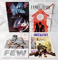 All four comic books laid out: Die, The Family Trade, The Few, Excellence